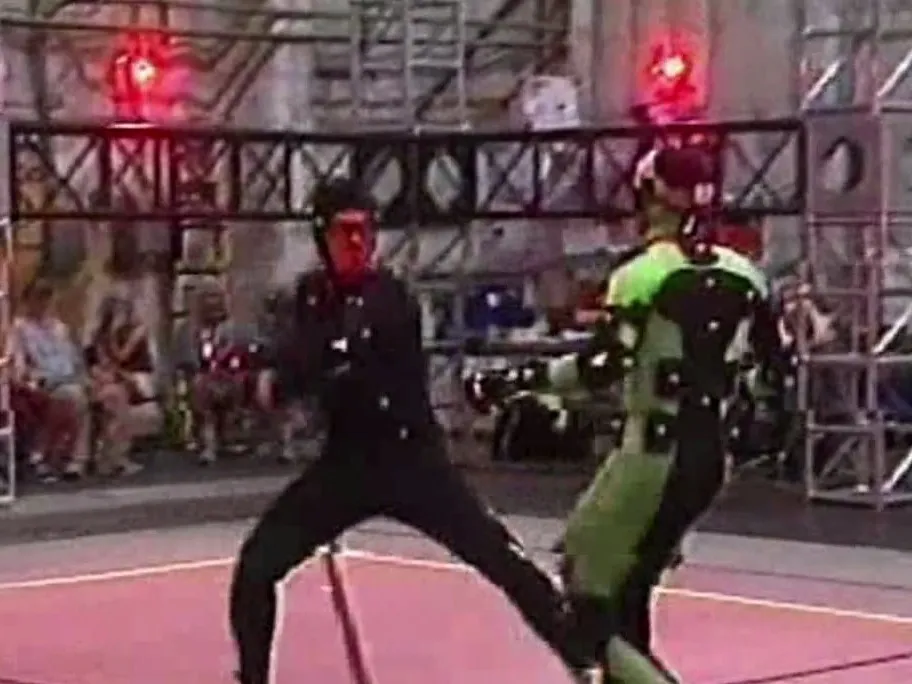 Two performers in motion-capture suits sparring on the capture stage
